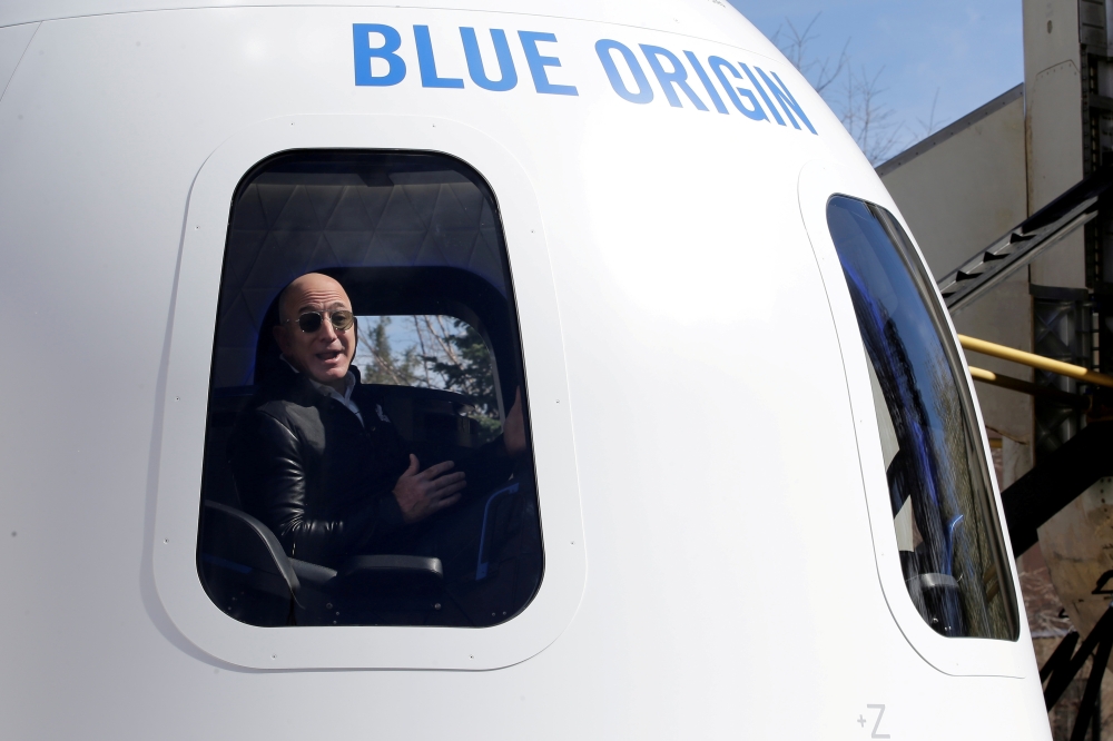 Amazon and Blue Origin founder Jeff Bezos addresses the media about the New Shepard rocket booster and Crew Capsule mockup at the 33rd Space Symposium in Colorado Springs, Colorado, United States April 5, 2017. REUTERS/Isaiah J. Downing/File Photo/File Ph
