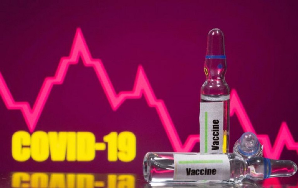 FILE PHOTO: A test tube labelled with the Vaccine is seen in front of Covid-19 and stock graph logo in this illustration taken, September 9, 2020. REUTERS/Dado Ruvic/Illustration/File Photo
