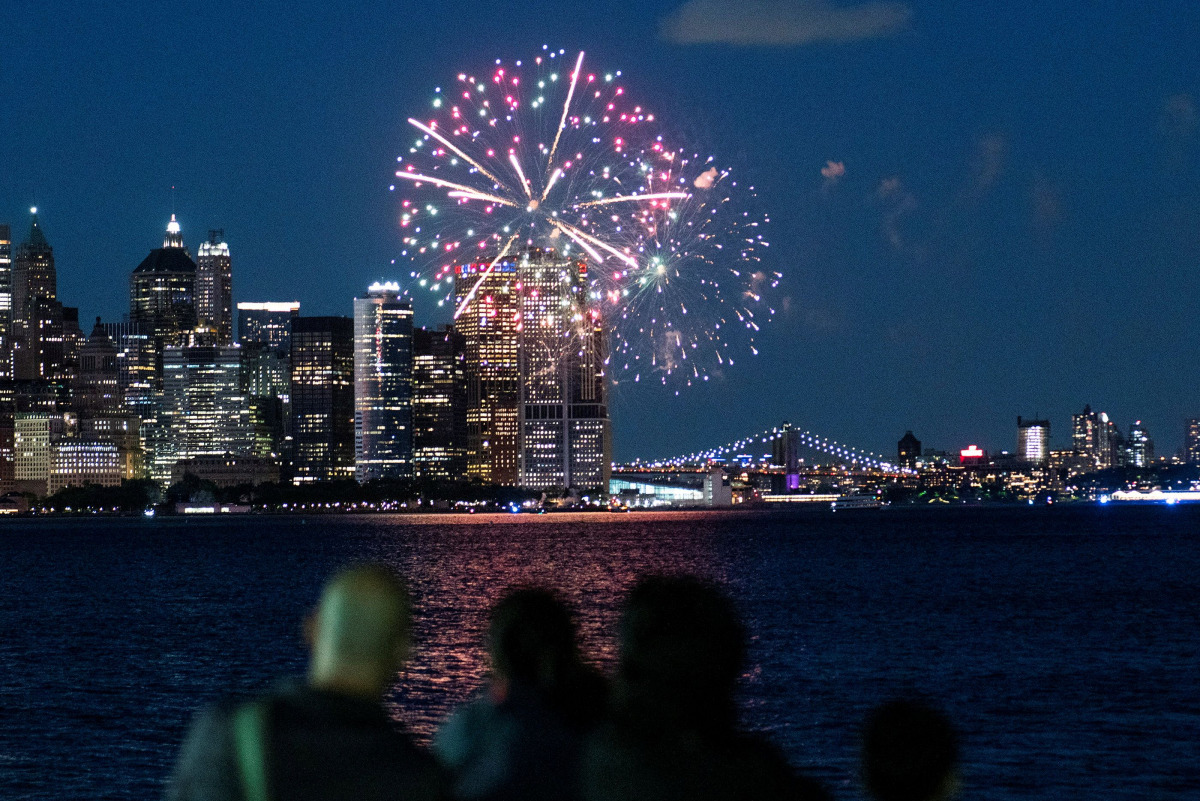 People watch fireworks in the New York City Harbor, as New York State celebrates reaching a 70 percent vaccination threshold for the coronavirus disease (COVID-19), as seen from Jersey City, New Jersey, U.S., June 15, 2021. REUTERS/Eduardo Munoz
