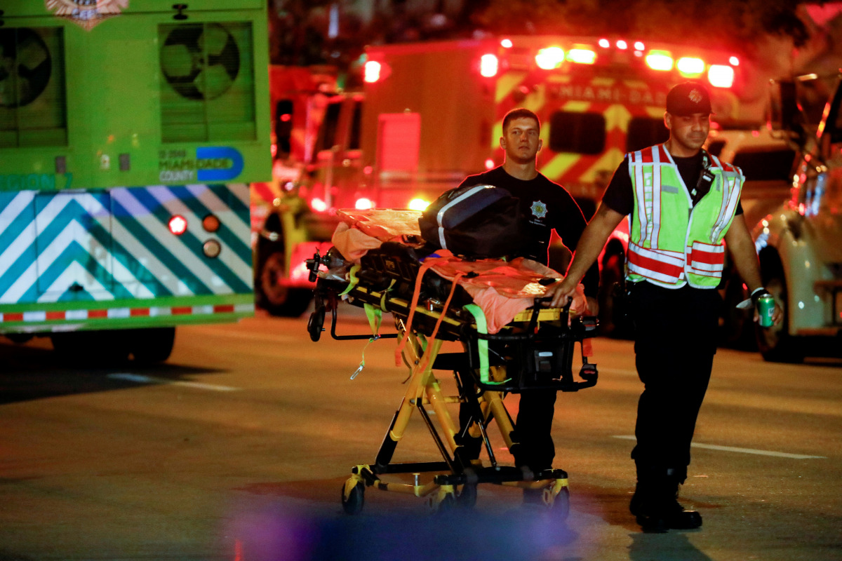 Emergency personnel work at the scene of a partial building collapse in Surfside near Miami Beach, Florida, U.S., June 24, 2021. REUTERS/Marco Bello 

