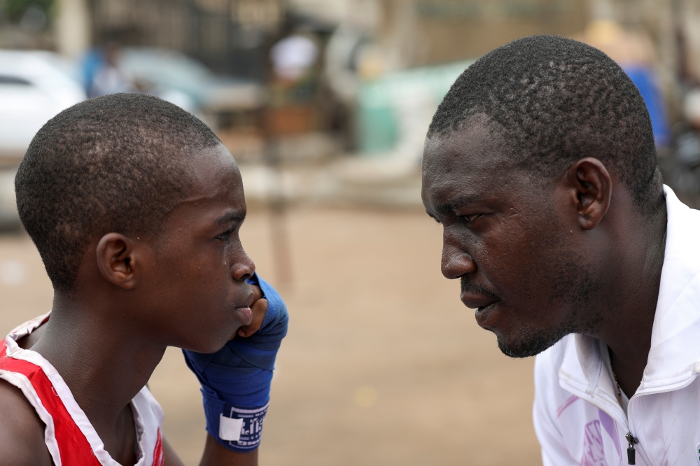 Boxer Tijani Abdulazeez, popularly known as TJ, 15, trains with his father, Abdulfathi Abdulazeez, at an outdoor boxing gym in Adura playground, in Lagos, Nigeria June 5, 2021. Picture taken June 5, 2021. REUTERS/Temilade Adelaja