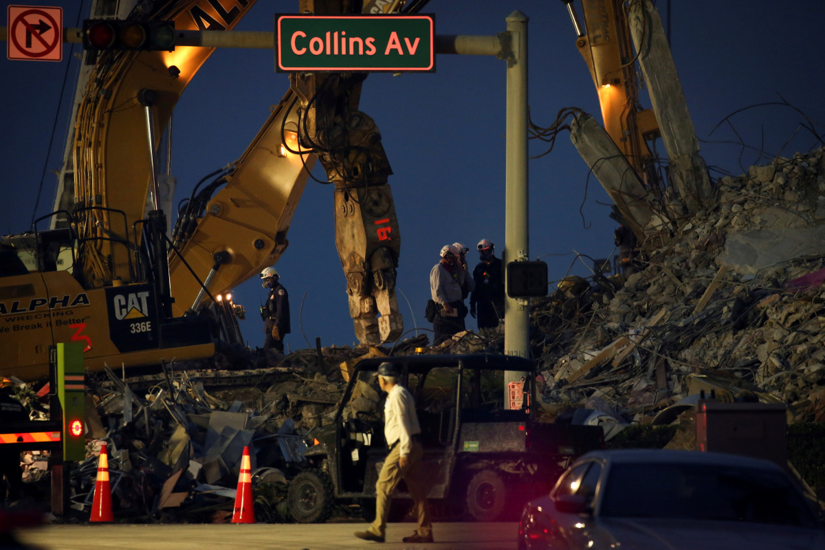 Rescue workers are seen after the managed demolition of the remaining part of Champlain Towers South complex as search-and-rescue efforts continue in Surfside, Florida, U.S. July 6, 2021. REUTERS/Marco Bello 

