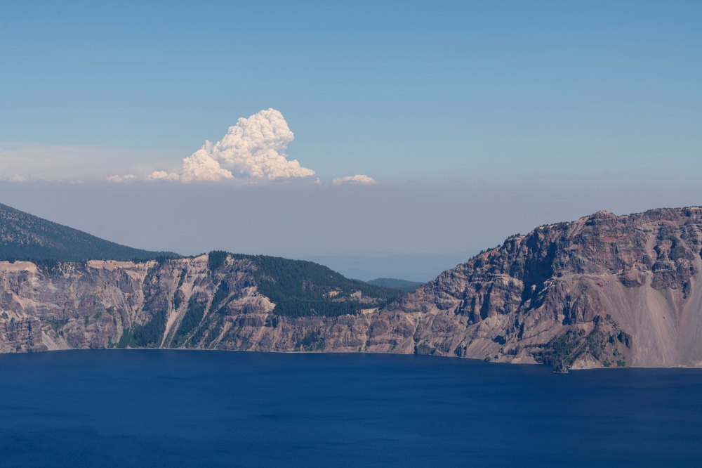 Plumes of smoke from the Bootleg Fire can be seen from 70 miles away at Crater Lake National Park, Oregon, U.S., July 16, 2021 as the fire. REUTERS/Mathieu Lewis-Rolland