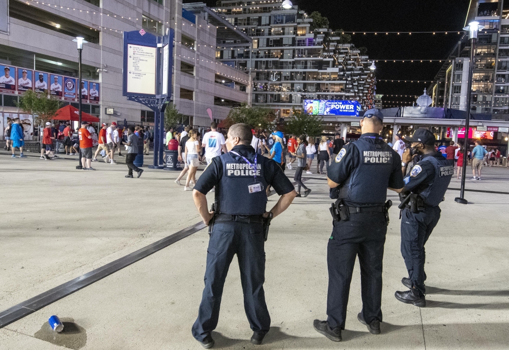 Police oversee the exiting of fans after the game between the Washington Nationals and the San Diego Padres was suspended due to gunshots outside the stadium at Nationals Park. Mandatory Credit: Brad Mills-USA TODAY Sports