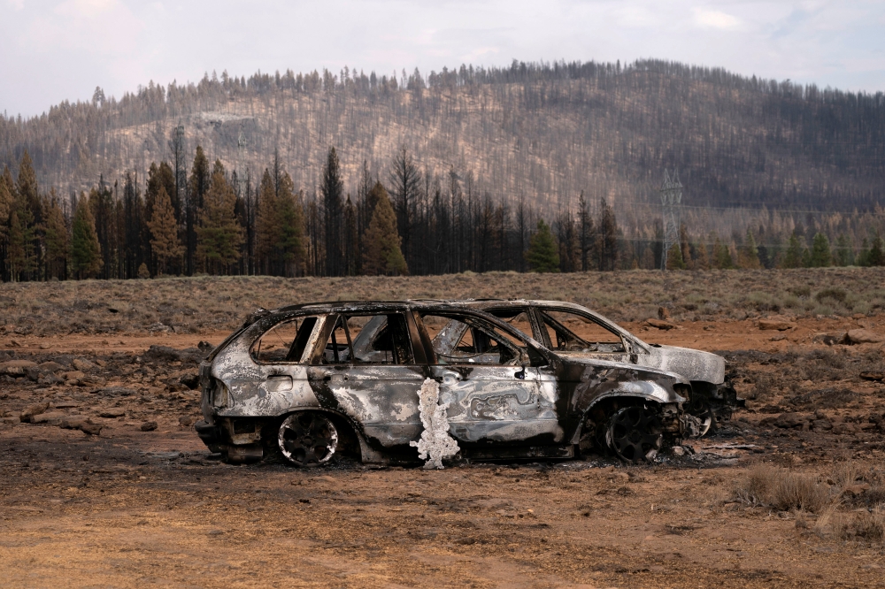 The remnants of cars destroyed by the Bootleg Fire are seen in a small community near Beatty, Oregon, U.S., July 19, 2021. REUTERS/David Ryder