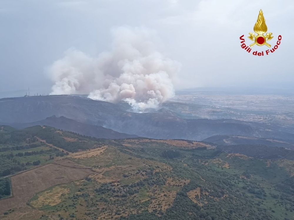 An aerial view from a helicopter shows a large wildfire that broke out near Santu Lussurgiu, Sardinia, Italy July 25, 2021. Vigili del Fuoco/Handout via REUTERS