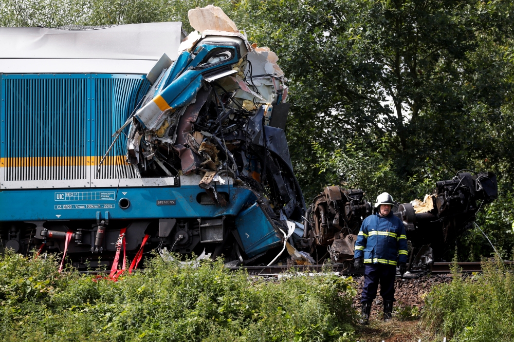 An emergency personnel works on a site of a train crash near the town of Domazlice, Czech Republic, August 4, 2021. REUTERS/David W Cerny