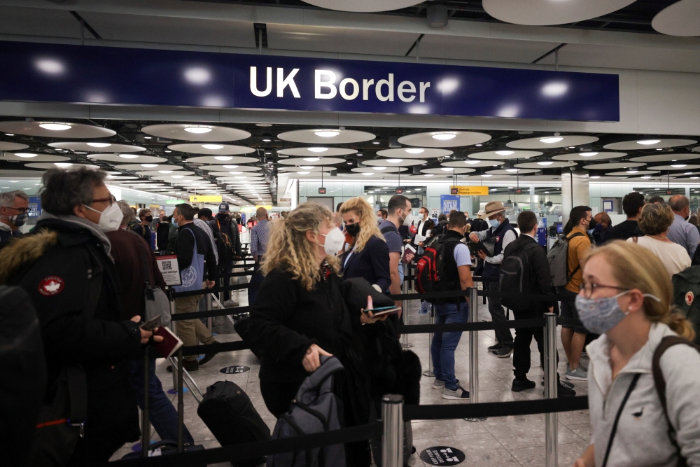 File photo: Arriving passengers queue at UK border Control at the Terminal 5 at Heathrow Airport in London, Britain June 29, 2021. Reuters/Hannah Mckay/File Photo