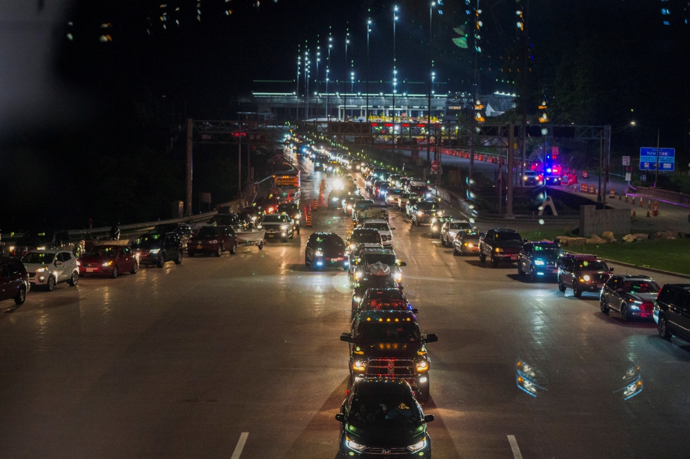 Travellers line up to enter Canada after border restrictions were loosened to allow fully vaccinated U.S. residents, after the coronavirus disease (COVID-19) pandemic forced an unprecedented 16-month ban, at the Thousand Islands Bridge crossing in Lansdow