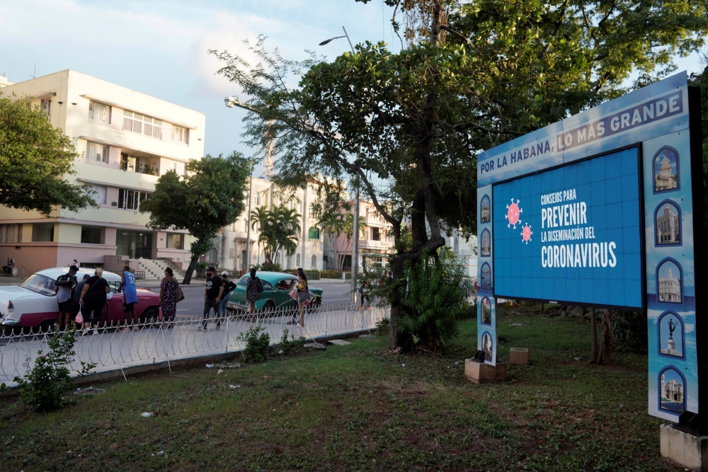 A screen displays images concerning the spread of the coronavirus disease (COVID-19), in Havana, Cuba, August 9, 2021. Photo taken on August 9, 2021. REUTERS/Alexandre Meneghini