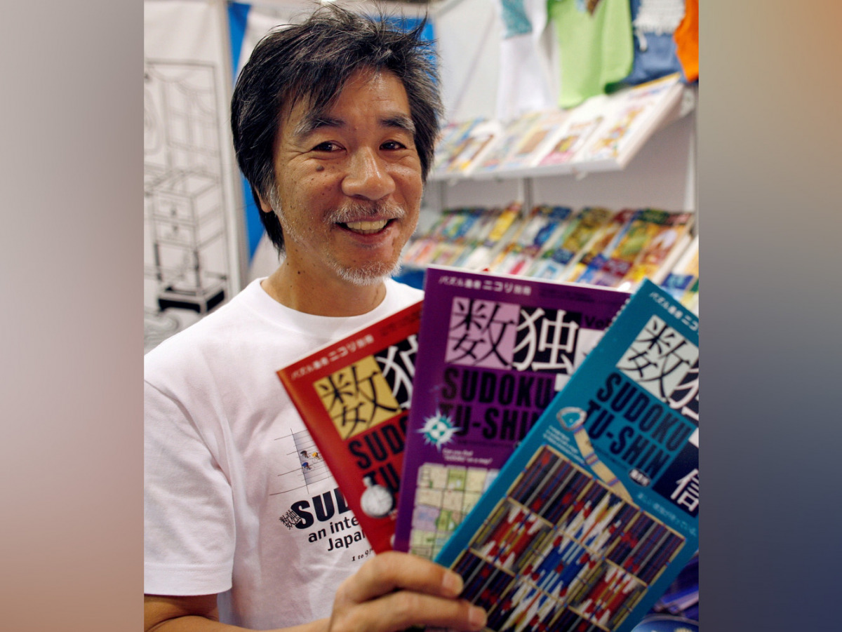 File photo: 'Father of Sudoku' Maki Kaji holds copies of the latest sudoku puzzles at the Book Expo, in New York, June 3, 2007. REUTERS/Chip East/File Photo
