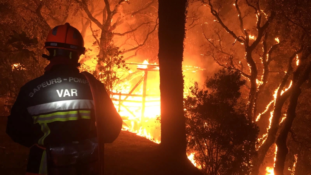 A firefighter works near at the site of a wildfire that broke out in the Var region of southern France, August 17, 2021 Communication SDIS19/Handout via REUTERS