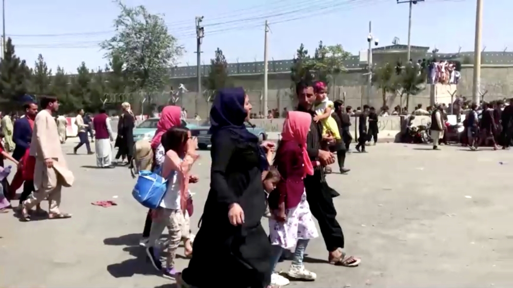 People gather outside Kabul airport, Afghanistan August 16, 2021, in this still image taken from a video.  REUTERS