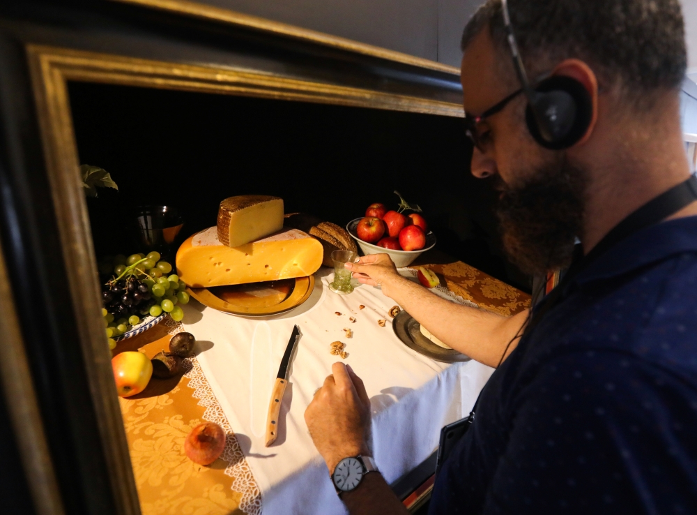 A visually impaired visitor, Farid el Manssouri, touches during the exhibition 