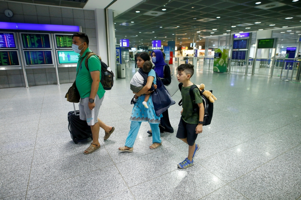 A family of German citizens walk with their bags in the airport terminal upon arrival at Frankfurt Airport, Germany, August 18, 2021, after being evacuated from Kabul, Afghanistan. Reuters/Thilo Schmuelgen