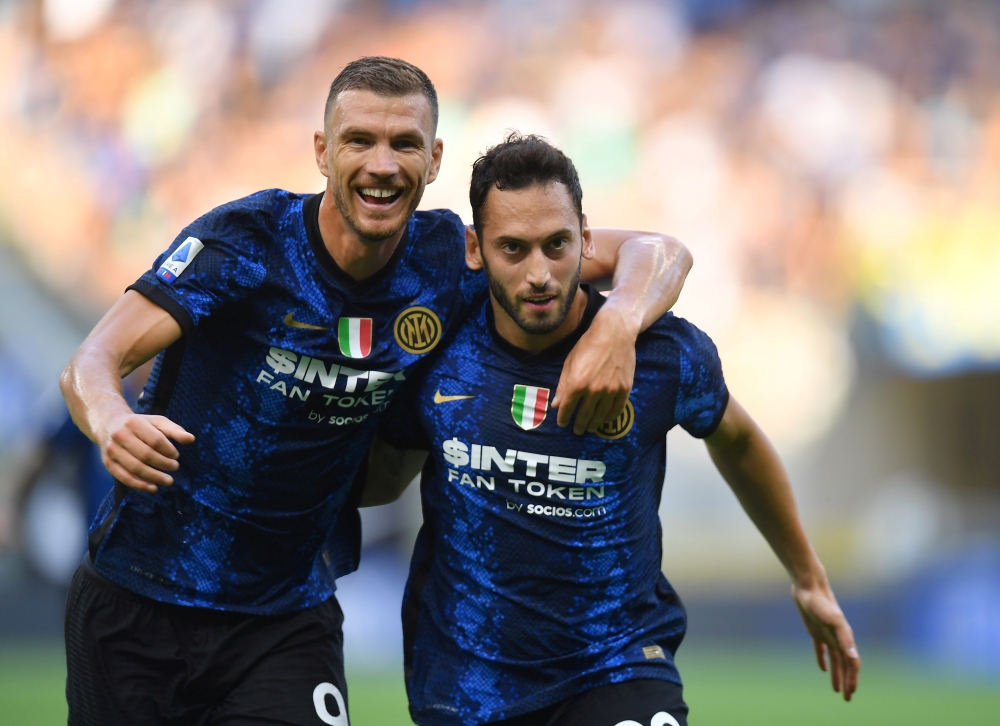 Inter Milan's Hakan Calhanoglu celebrates scoring their second goal with Edin Dzeko REUTERS/Daniele Mascolo 