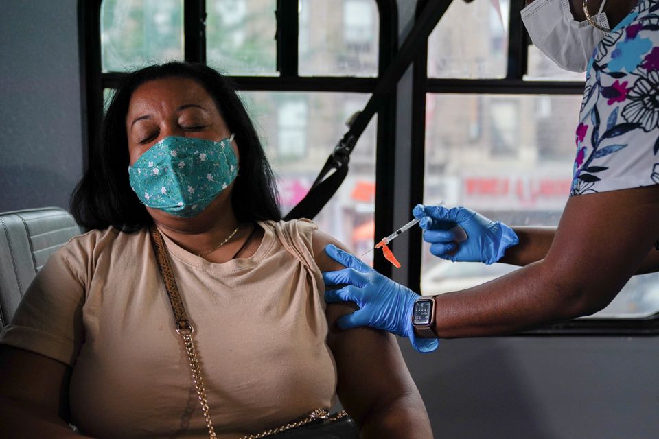 A person receives a dose of the Pfizer-BioNTech vaccine for the coronavirus disease (COVID-19), at a mobile inoculation site in the Bronx borough of New York City, New York, U.S., August 18, 2021. REUTERS/David 'Dee' Delgado


