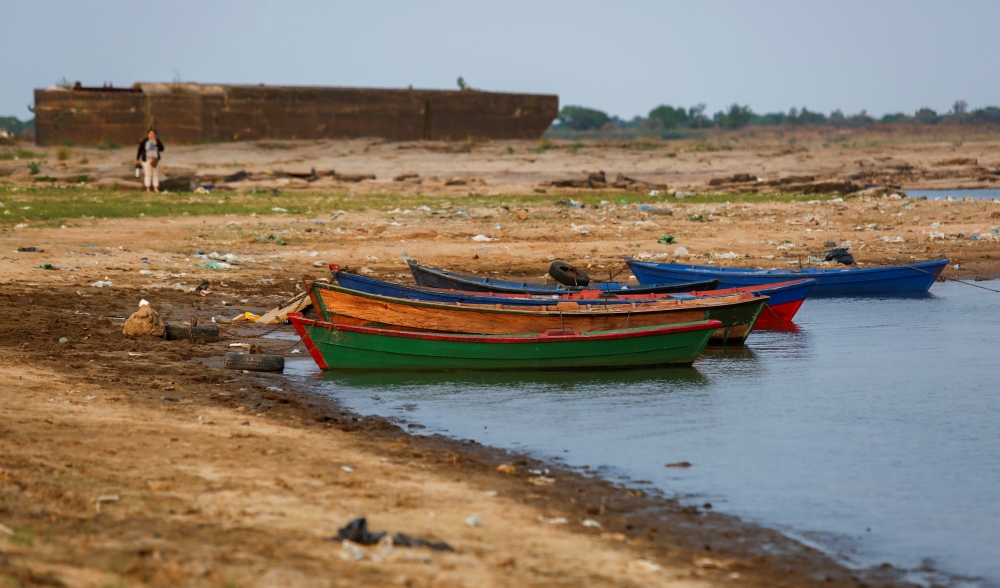 Boats are pictured on the shore of the Rio Paraguay (Paraguay River), which flows down to the Parana River, as the lack of rain in Brazil, where the river originates, has brought water levels down, forcing cargo ships to reduce the amount of grains that a