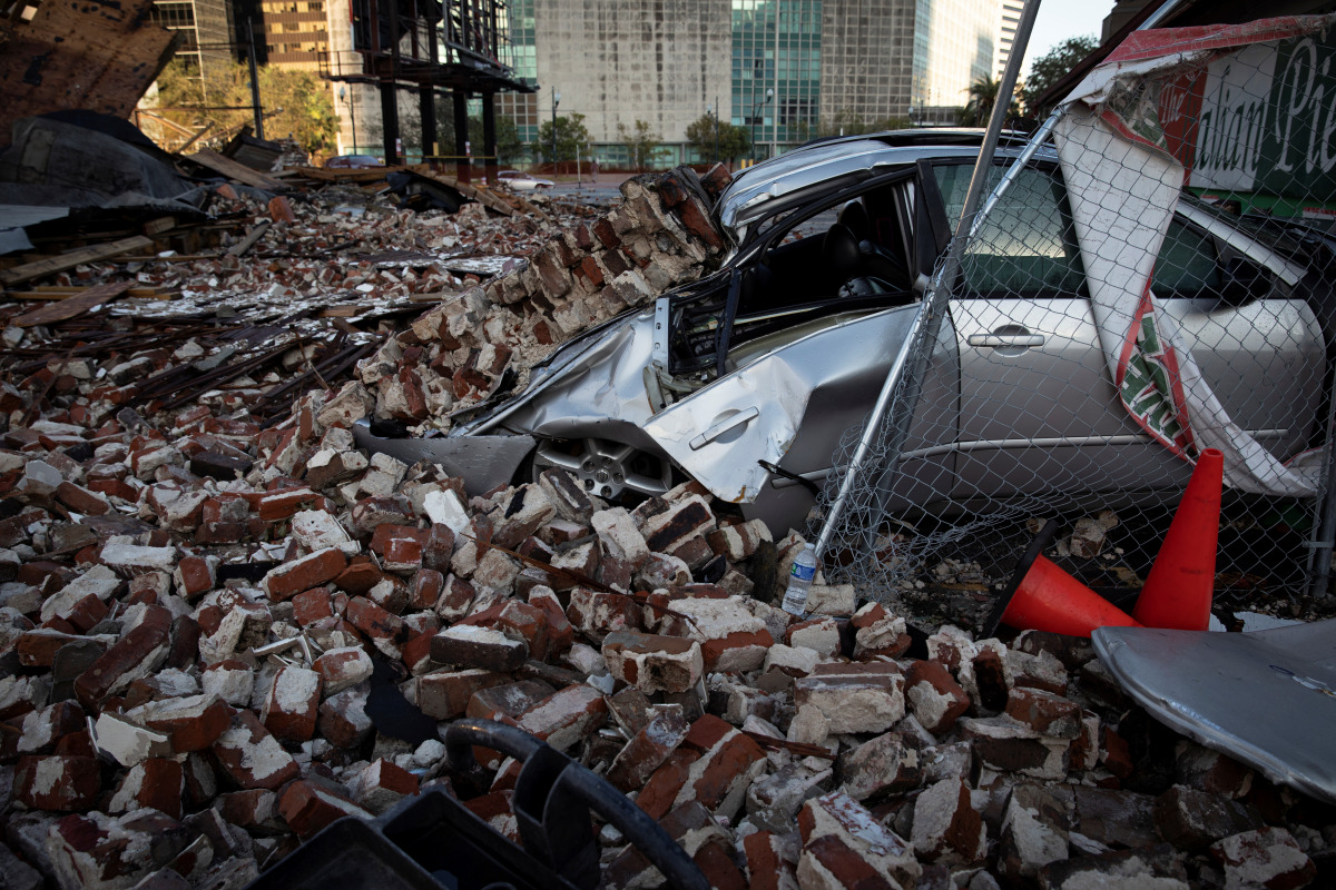 A destroyed car is seen under the debris of a building after Hurricane Ida made landfall in Louisiana, U.S., August 31, 2021. REUTERS/Marco Bello
