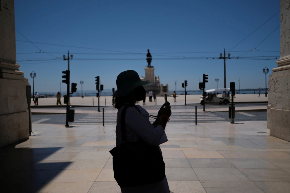 A person takes a picture in Lisbon downtown amid the coronavirus disease (COVID-19) pandemic, in Lisbon, Portugal, June 24, 2021. REUTERS/Pedro Nunes/File Photo