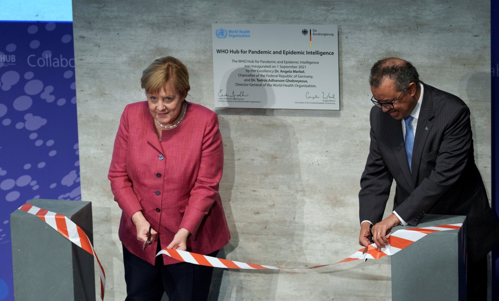 Tedros Adhanom Ghebreyesus (R), Director-General of the World Health Organization (WHO), and German Chancellor Angela Merkel attend the inauguration ceremony of the 'WHO Hub For Pandemic And Epidemic Intelligence' at the Langenbeck-Virchow building in Ber