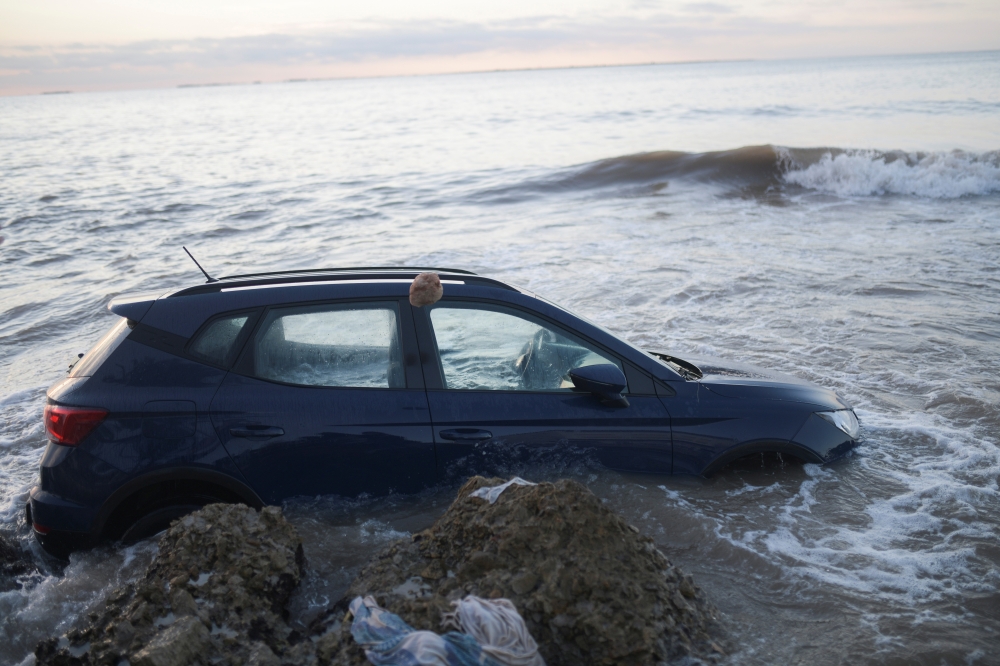 A car is seen in the sea after floods caused by heavy rains in Alcanar, Spain September 2, 2021. REUTERS/Lorena Sopena