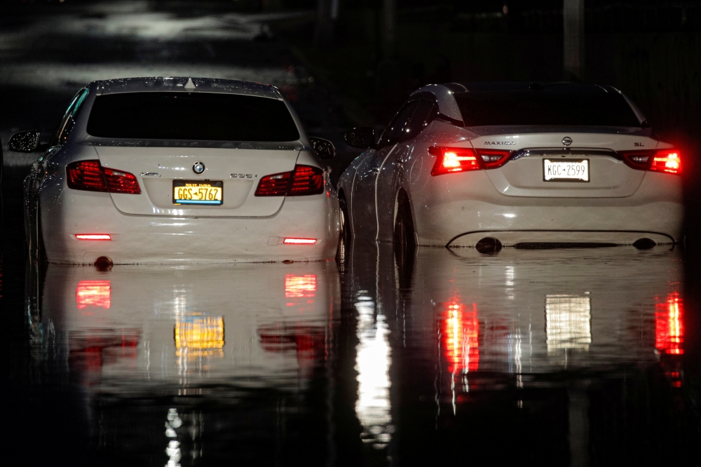 Abandoned cars are left on a flooded highway, as local media reported the remnants of Tropical Storm Ida bringing drenching rain and the threat of flash floods and tornadoes to parts of the northern mid-Atlantic, in the Queens borough of New York City, U.