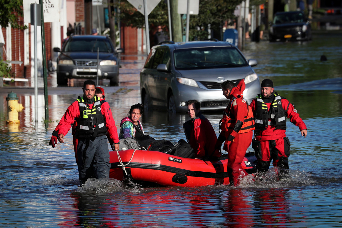 First responders pull local residents in a boat as they perform rescues of people trapped by floodwaters after the remnants of Tropical Storm Ida brought drenching rain, flash floods and tornadoes to parts of the northeast in Mamaroneck, New York, U.S., S