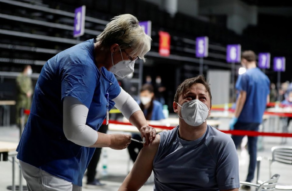 A man receives a dose of the coronavirus disease (COVID-19) vaccine during a trial run of the national vaccination centre located inside the O2 Arena in Prague, Czech Republic, April 9, 2021. REUTERS/David W Cerny