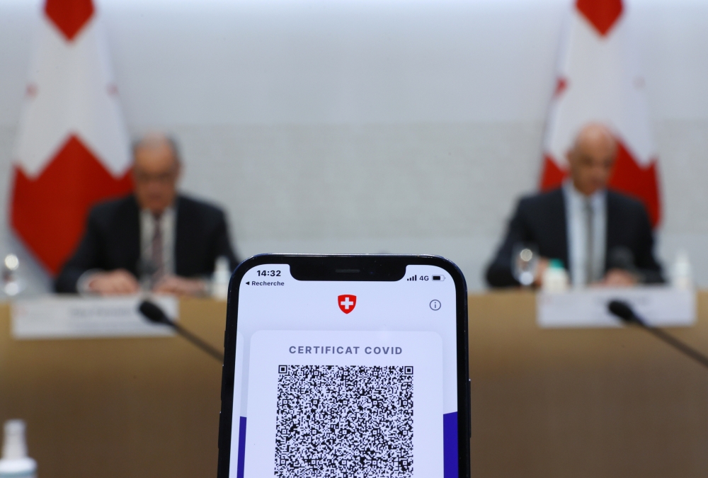 A COVID certificate is pictured on a mobile device during the news conference of Swiss Interior Minister Alain Berset and Guy Parmelin President of the Swiss Confederation on the outbreak of the coronavirus disease (COVID-19) in Bern, Switzerland, Septemb