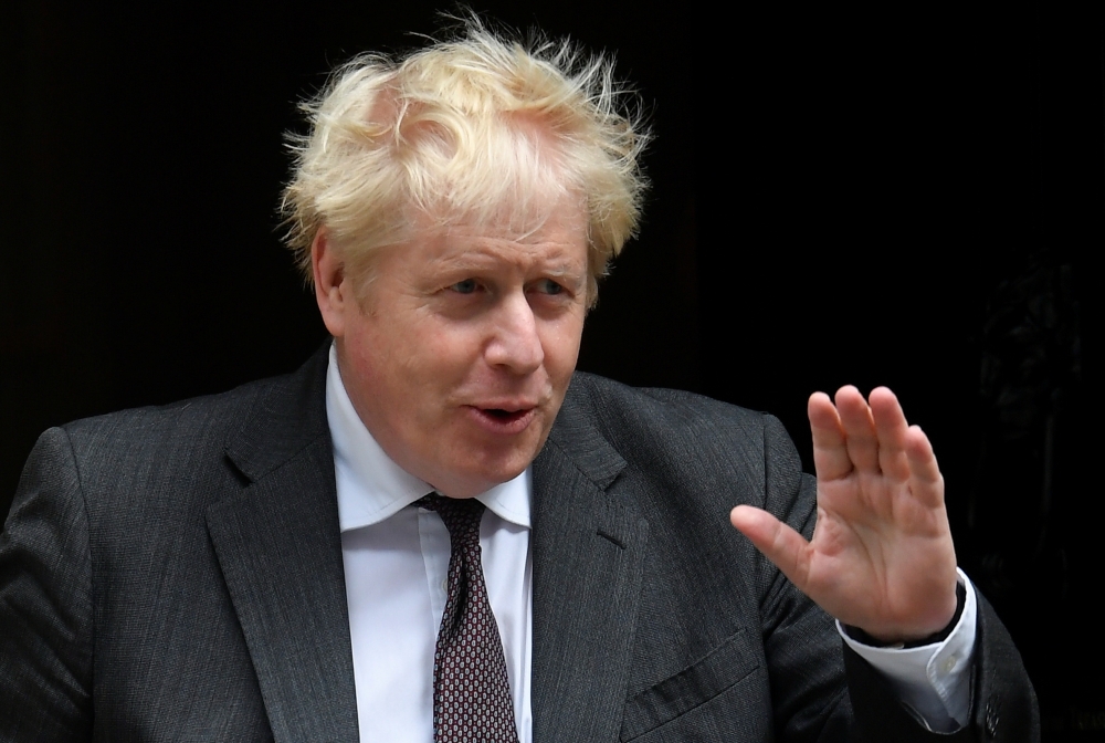 Britain's Prime Minister Boris Johnson gestures as he walks outside Downing Street in London, Britain, September 15, 2021. REUTERS/Toby Melville