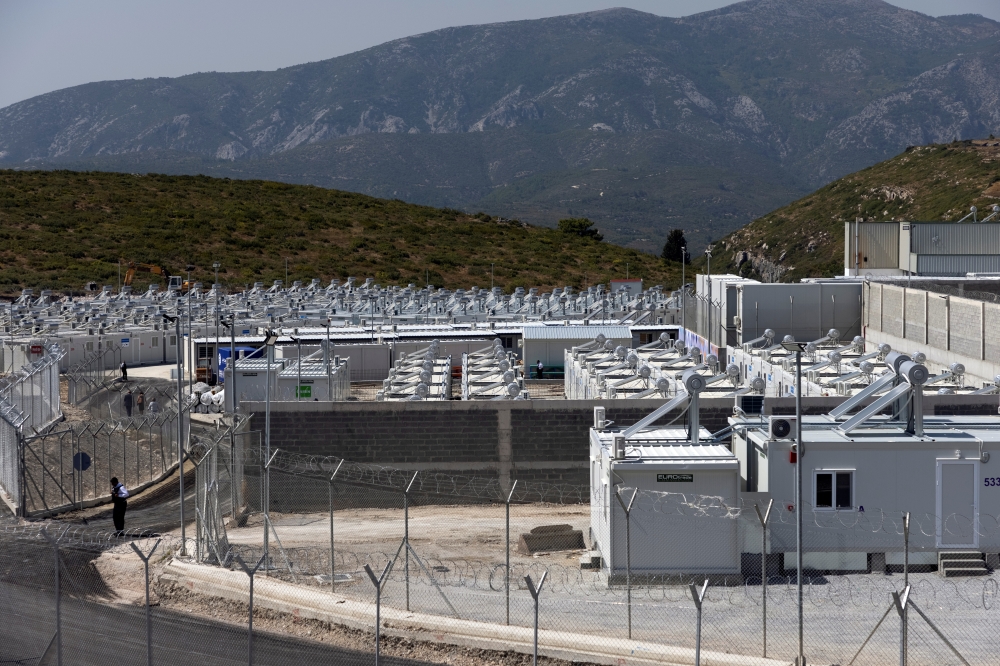 A private security employee stands guard inside a newly inaugurated closed-type migrant camp on the island of Samos, Greece, September 18, 2021. REUTERS/Alkis Konstantinidis