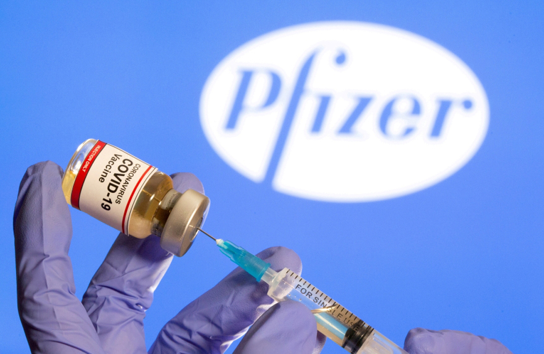 FILE PHOTO: FILE PHOTO: A woman holds a small bottle labeled with a 