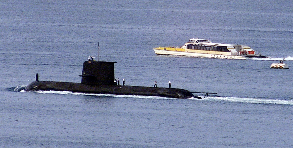 File photo: A Rivercat ferry passes by the Royal Australian Navy's Collins-class submarine HMAS Waller as it leaves Sydney Harbour on May 4, 2020. 
