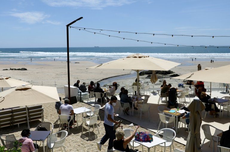 People sit at an outdoor restaurant terrace on the first day that tourists from Britain and most EU countries are allowed to enter Portugal without needing to quarantine, as coronavirus disease (COVID-19) restrictions continue to ease, by the Matosinhos B