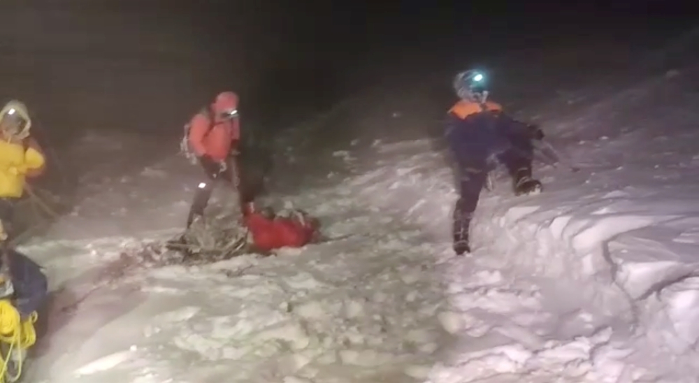 Members of Russia's Emergencies Ministry conduct a rescue operation after a group of climbers got stuck while climbing Mount Elbrus, in the Republic of Kabardino-Balkaria, Russia, in this still image from video taken September 23, 2021. Video taken Septem