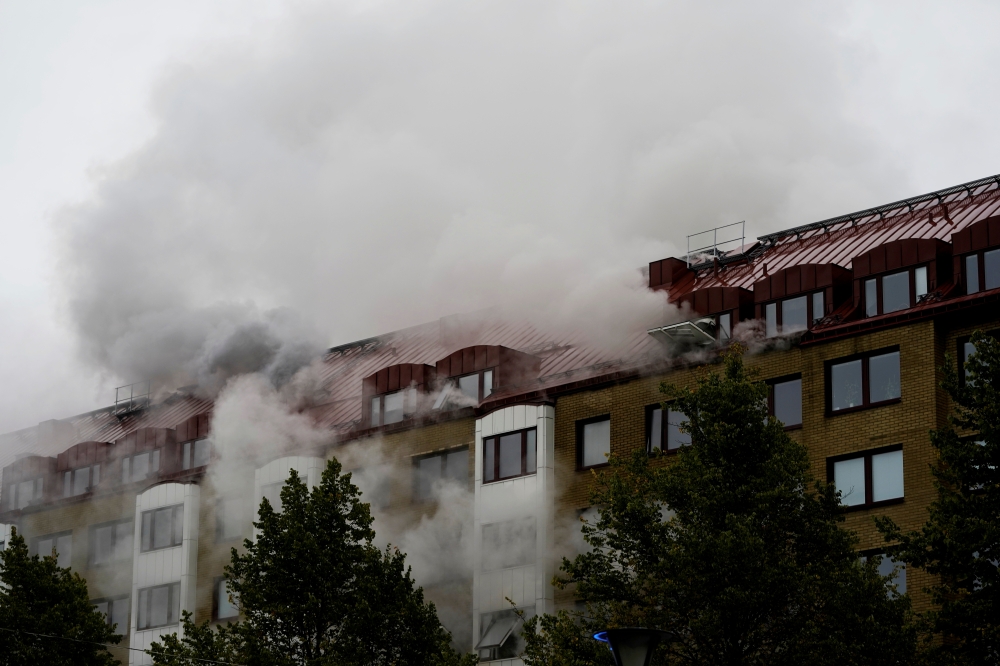 Smoke comes out of windows after an explosion hit an apartment building in Annedal, central Gothenburg, Sweden September 28, 2021. Larsson Rosvall / TT News Agency/via REUTERS