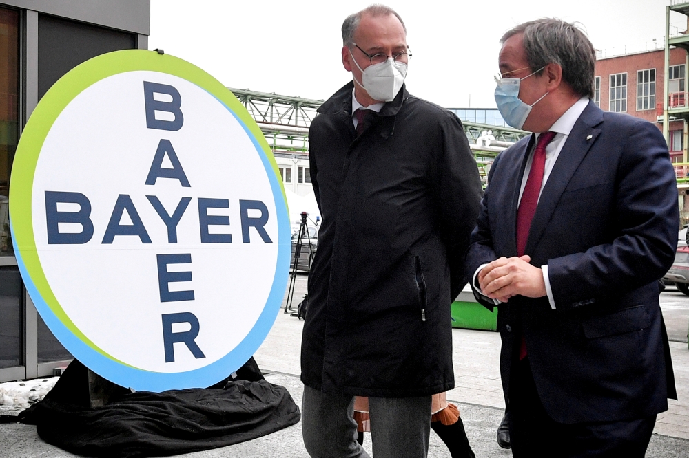 Prime Minister of North Rhine-Westphalia Armin Laschet and Werner Baumann, CEO of German pharmaceutical company Bayer AG, speak to the media following their visit to the future production site of CureVac's COVID-19 vaccine (CVnCoV) at the Bayer AG plant i