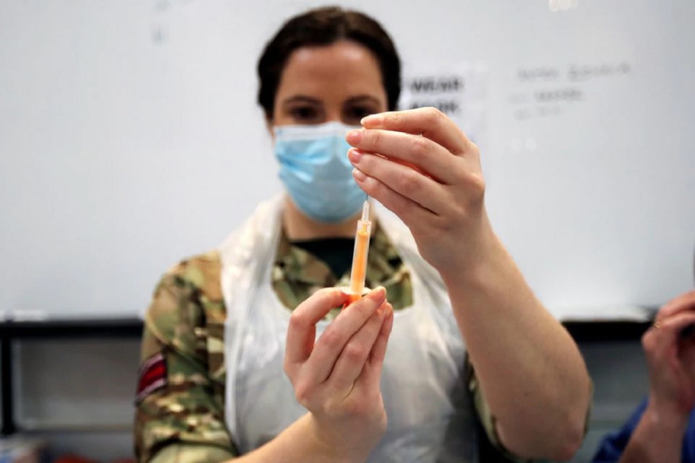 A healthcare worker prepares a dose of the coronavirus disease (COVID-19) vaccine at a vaccination centre inside the Blackburn Cathedral, in Blackburn, Britain, January 19, 2021. REUTERS/Molly Darlington