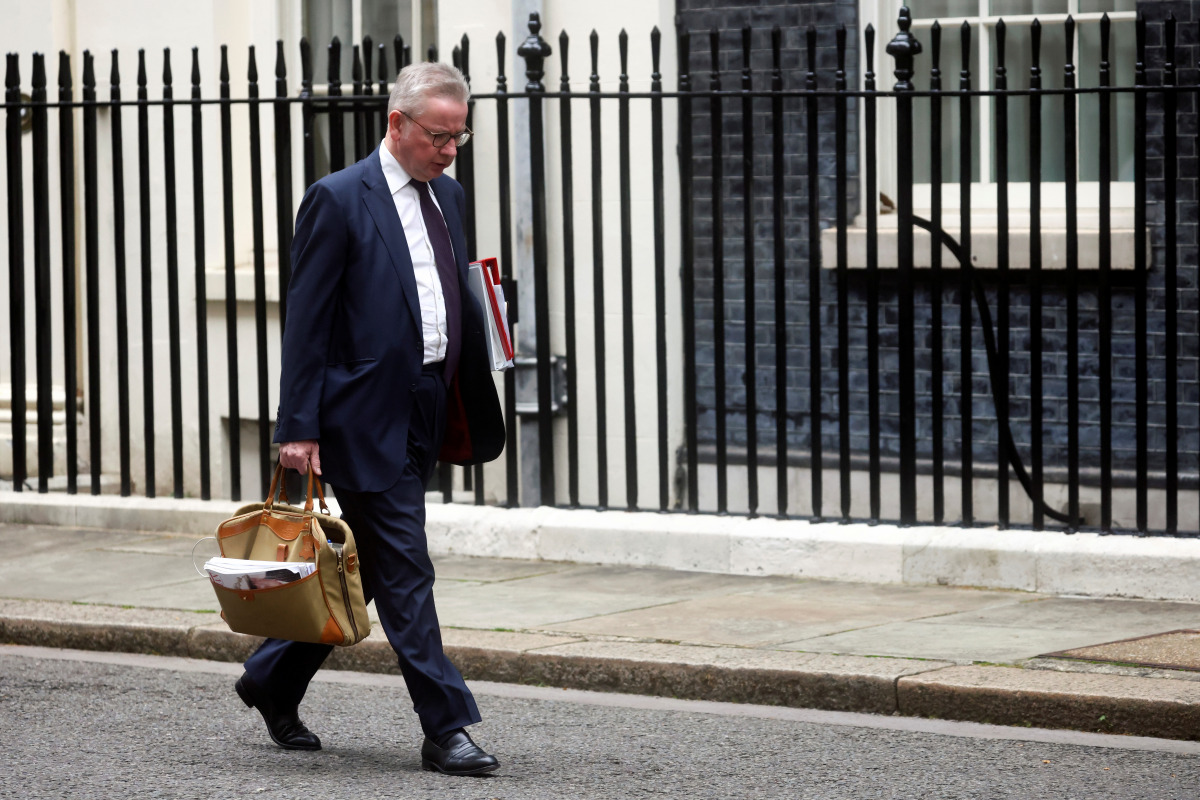 Britain's Housing Secretary Michael Gove walks outside Downing Street, following the death of British MP David Amess who was stabbed to death during a meeting with constituents, in London, Britain, October 18, 2021. REUTERS/Henry Nicholls
