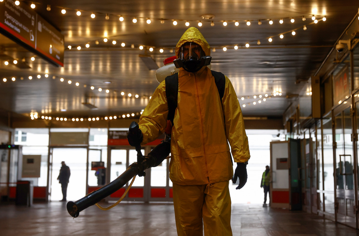 A specialist wearing personal protective equipment (PPE) sprays disinfectant while sanitizing the Leningradsky railway station amid the outbreak of the coronavirus disease (COVID-19) in Moscow, Russia October 19, 2021. REUTERS/Maxim Shemetov
