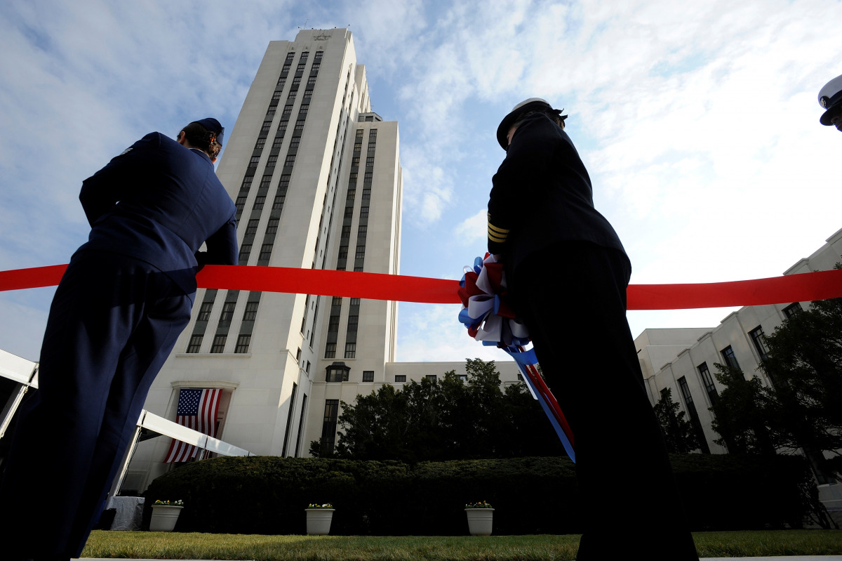 FILE PHOTO: U.S. service members hold the ribbon for a ribbon-cutting at the dedication ceremony for the Walter Reed National Military Medical Center in Bethesda, Maryland, November 10, 2011. REUTERS/Jonathan Ernst/File Photo
