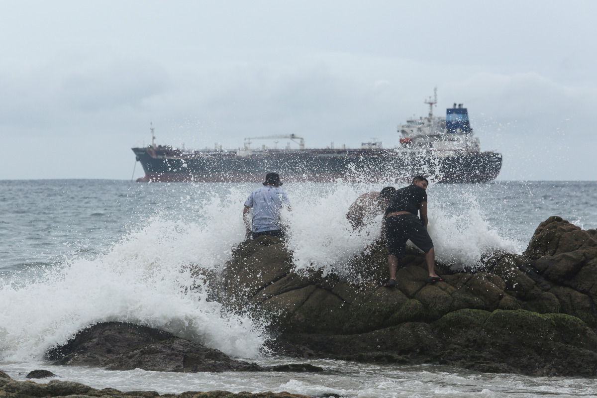 People are pictured on a beach as tropical Storm Rick strengthened into a hurricane off Mexico's Pacific coast, in Acapulco, Mexico October 23, 2021. REUTERS/Javier Verdin
