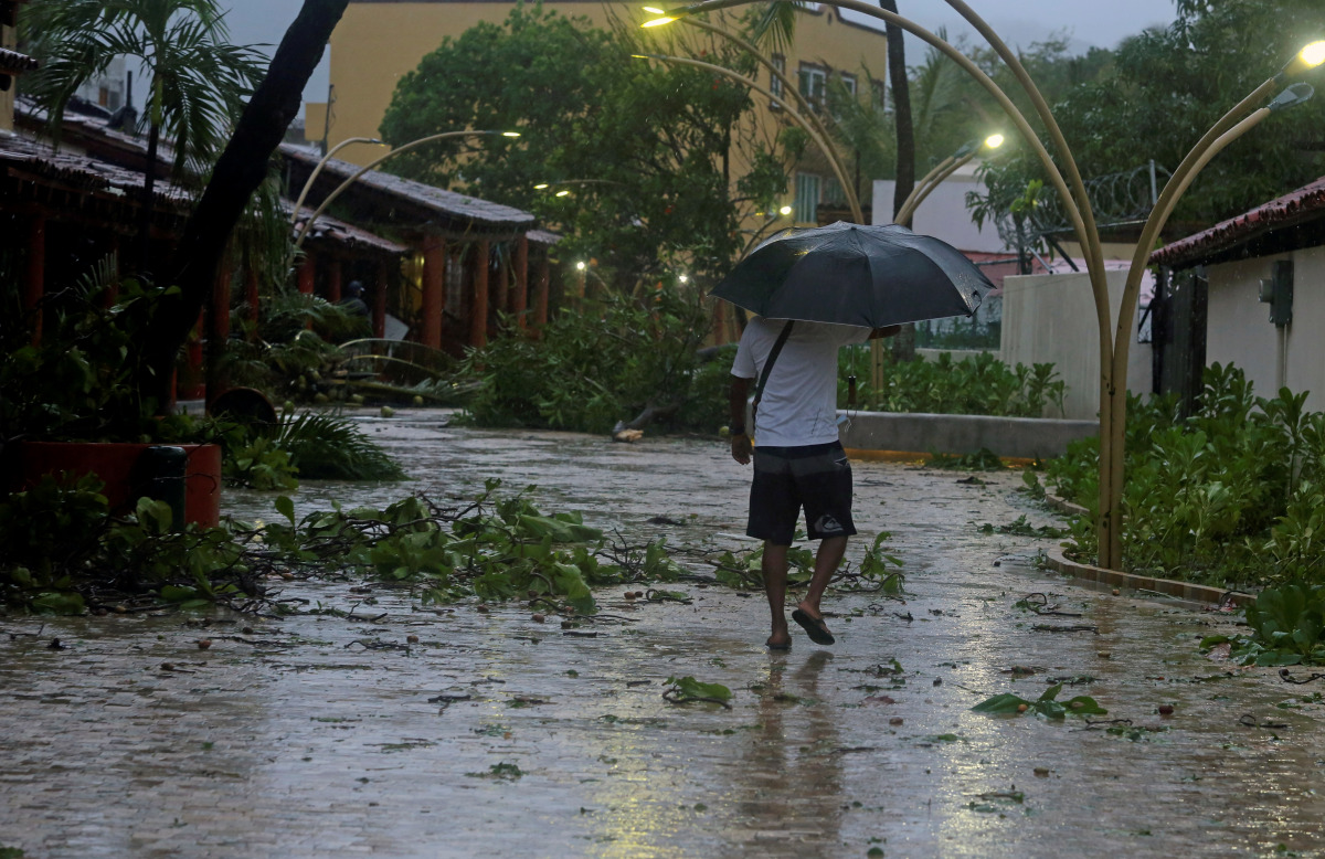 A man walks along a flooded street after Hurricane Rick hit in Zihuatanejo, in Guerrero state, Mexico October 25, 2021. REUTERS/Javier Verdin
