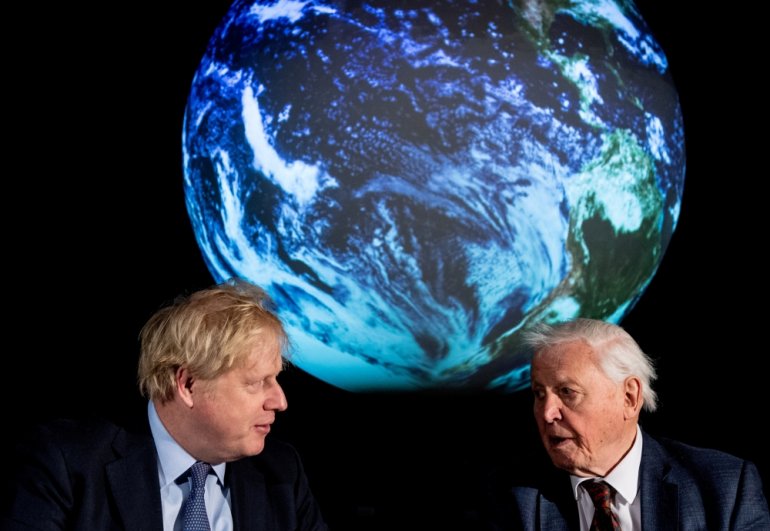 British Prime Minister Boris Johnson and David Attenborough speak with school children during a conference about the COP26 UN Climate Summit, at the Science Museum in London, Britain February 4, 2020. Chris J Ratcliffe/Pool via REUTERS/File Photo