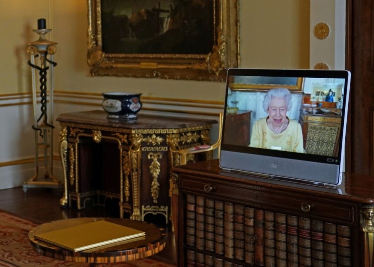 Britain's Queen Elizabeth appears on a screen via video link from Windsor Castle, where she is in residence, during a virtual audience to receive the Ambassador from the Republic of Korea, Gunn Kim, at Buckingham Palace, London, Britain, October 26, 2021.
