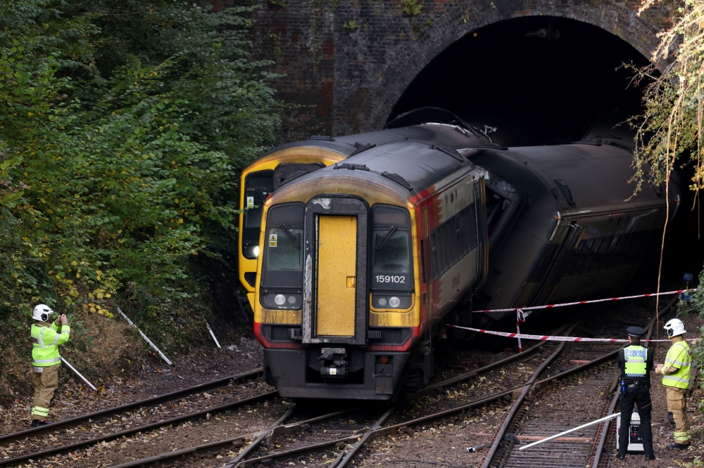 Emergency services personnel inspect the site where two trains collided near Salisbury, Britain, November 1, 2021. REUTERS/Tom Nicholson