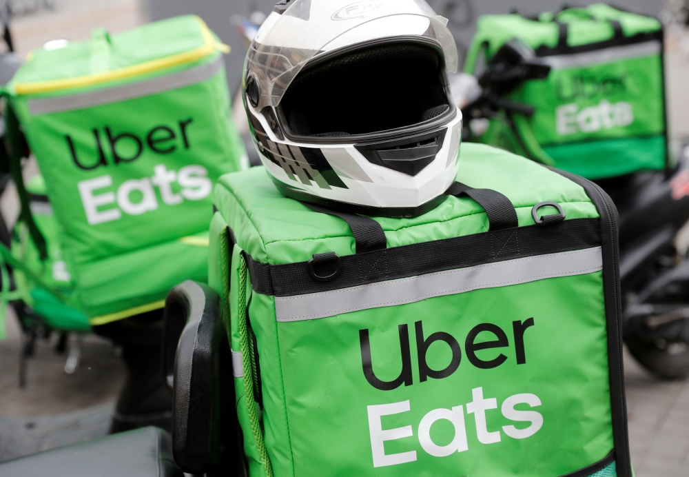 Delivery bags with logos of Uber Eats are seen on a street amid the outbreak of the coronavirus disease (COVID-19) in central Kiev, Ukraine May 27, 2020. Reuters/Valentyn Ogirenko/File Photo