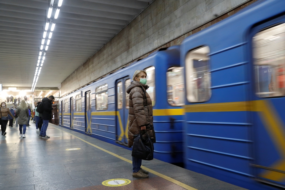 A woman wearing a protective face mask waits for a train at a subway station amid the coronavirus disease (COVID-19) outbreak in Kyiv, Ukraine November 1, 2021. REUTERS/Valentyn Ogirenko