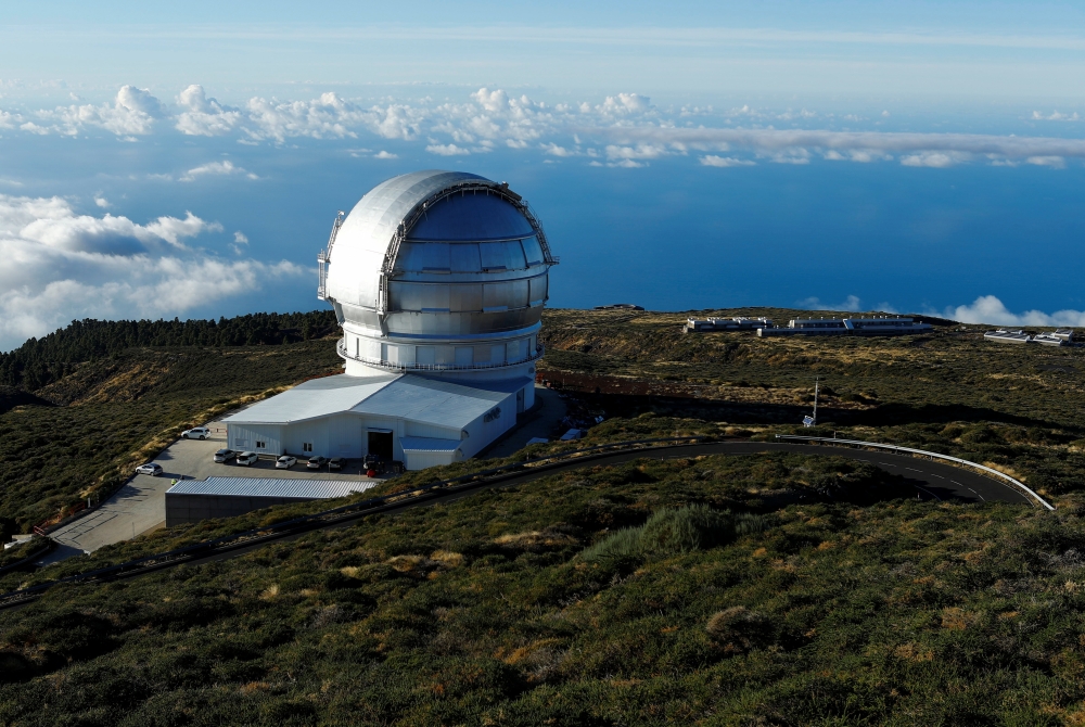 The world's largest GTC telescope is photographed from Roque De Los Muchachos. The eruption of Spain?s Cumbre Vieja volcano is disrupting activity at the Roque de Los Muchachos observatory. On the Canary Island of La Palma, Spain. October 28, 2021. REUTERS/Borja Suarez